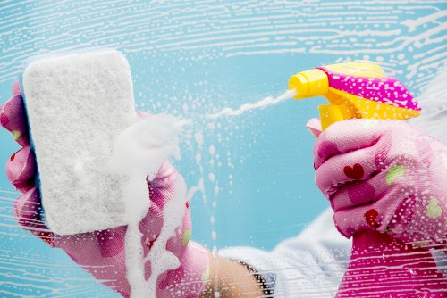 Cleaner preparing kitchen surfaces during a move-in clean in SW6